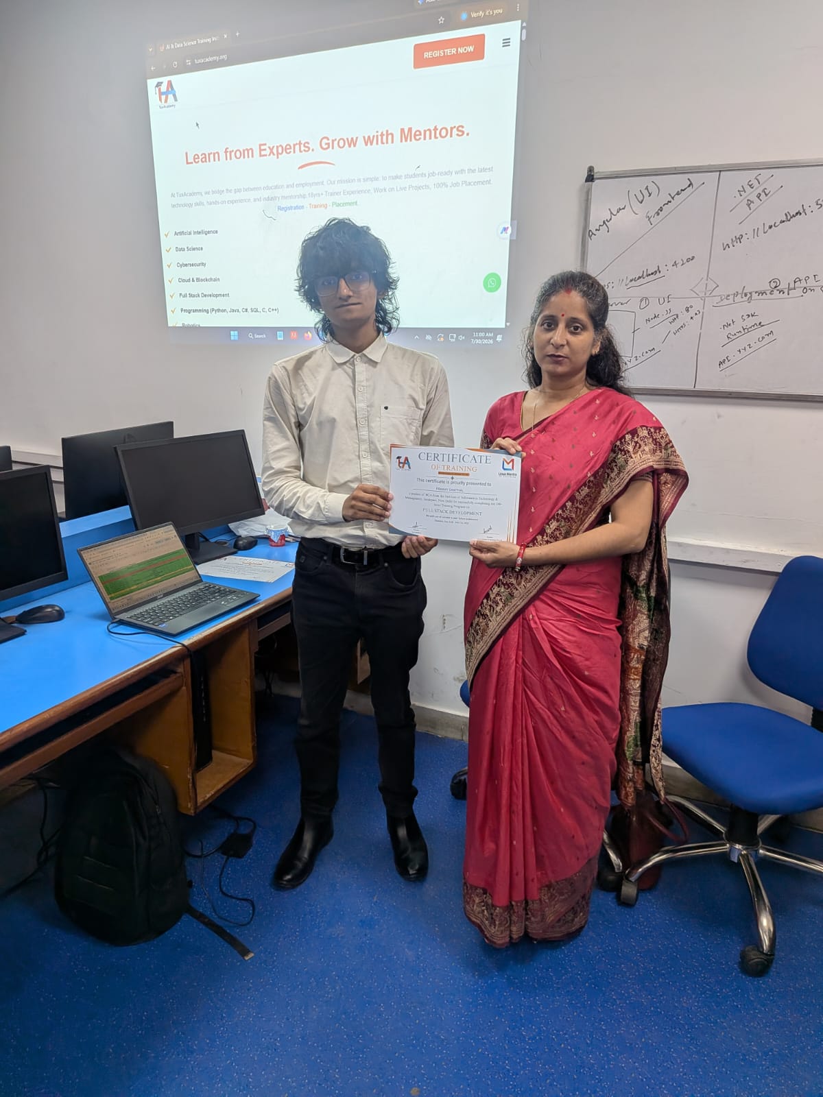 Student receiving Full Stack Development certificate at TuxAcademy