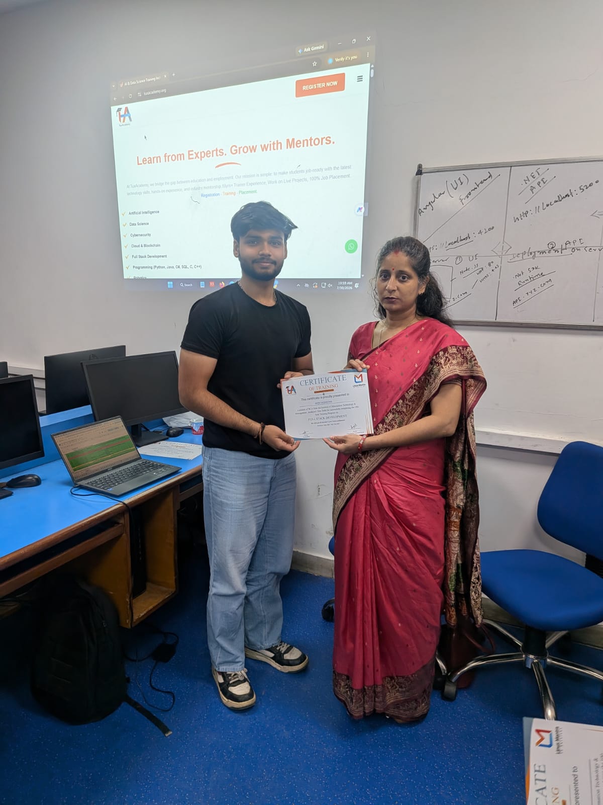Student receiving Full Stack Development certificate at TuxAcademy