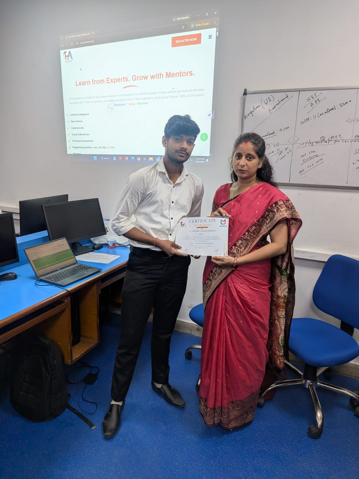 Student receiving Full Stack Development certificate at TuxAcademy