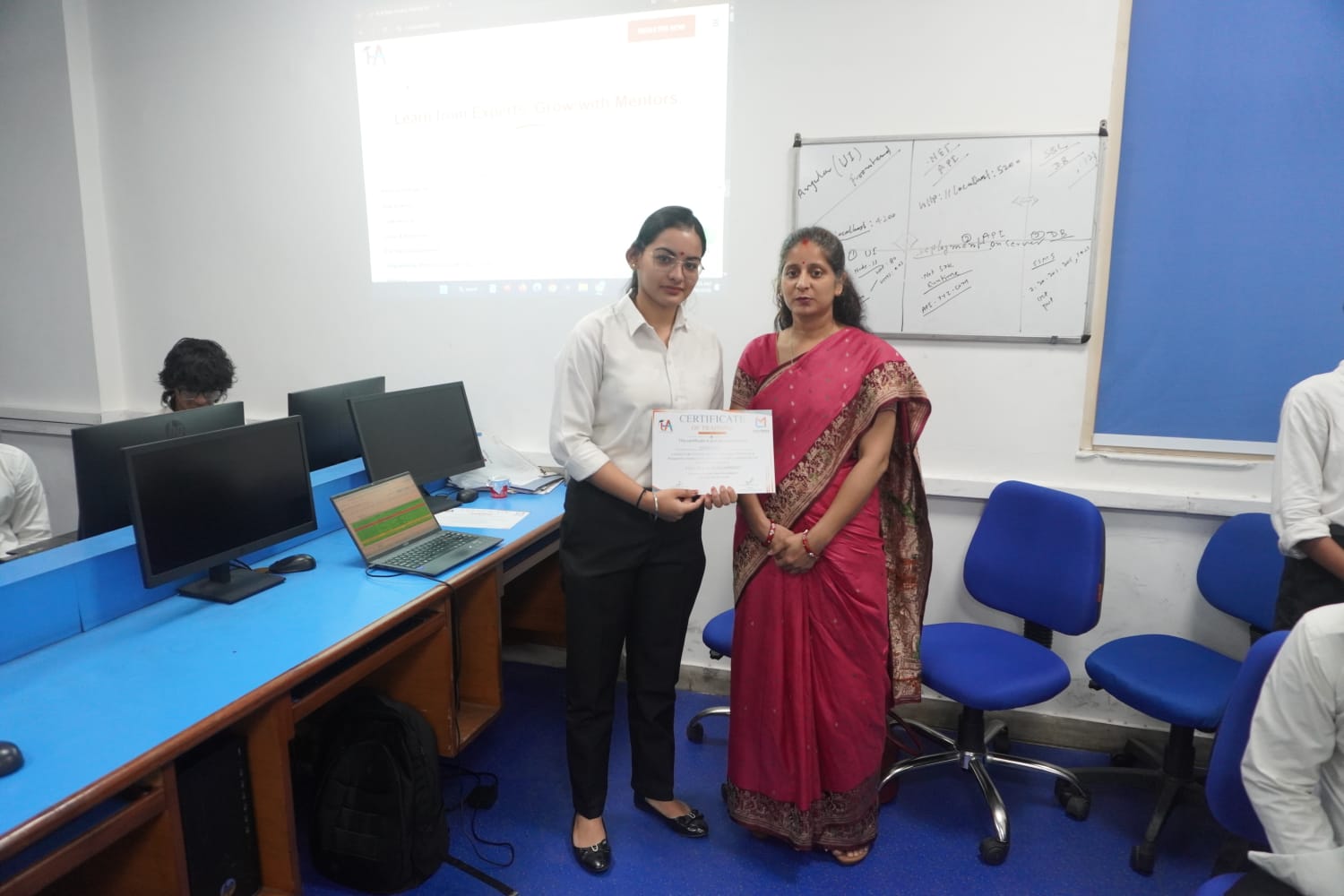 Student receiving Full Stack Development certificate at TuxAcademy