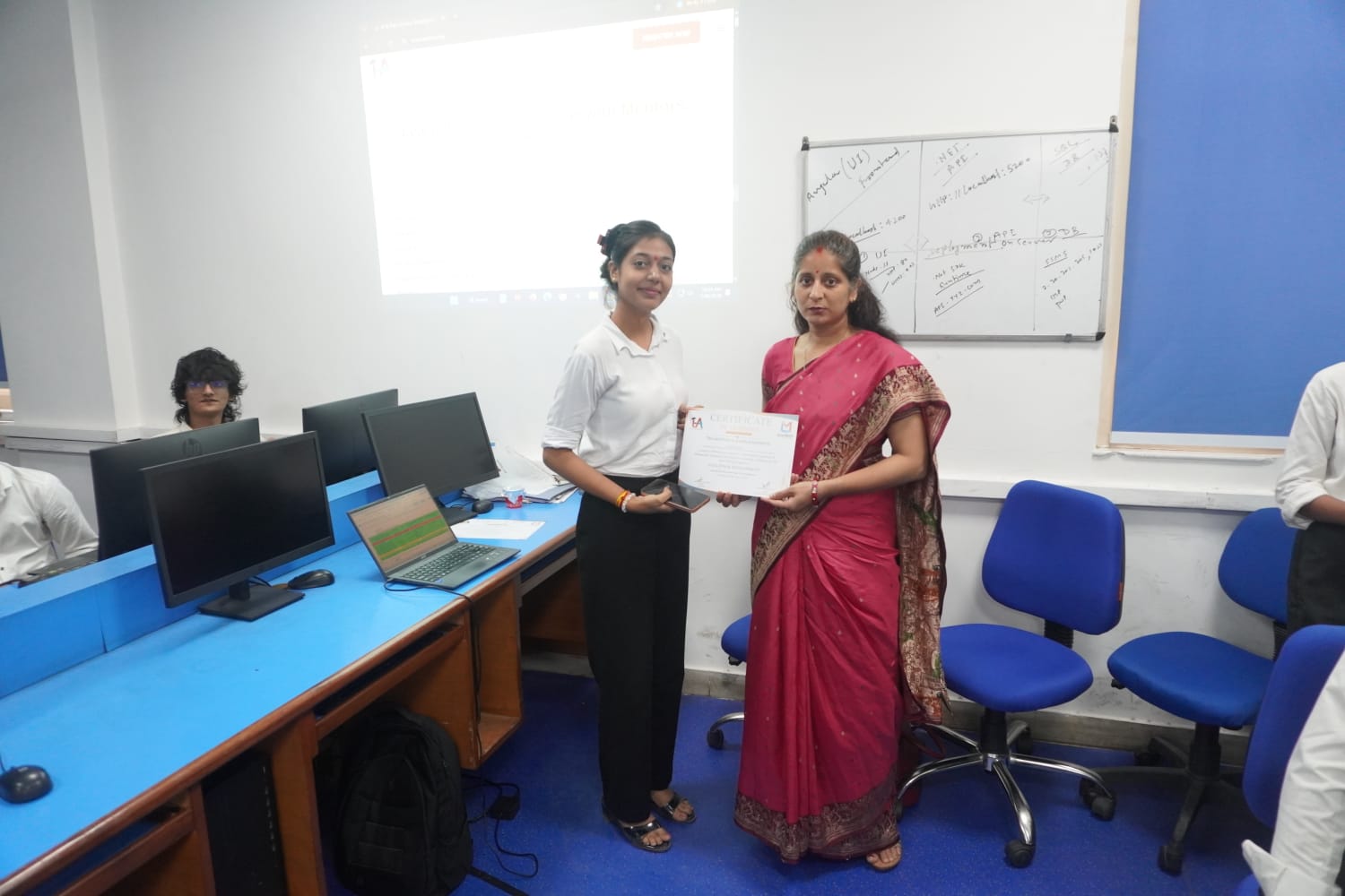 Student receiving Full Stack Development certificate at TuxAcademy