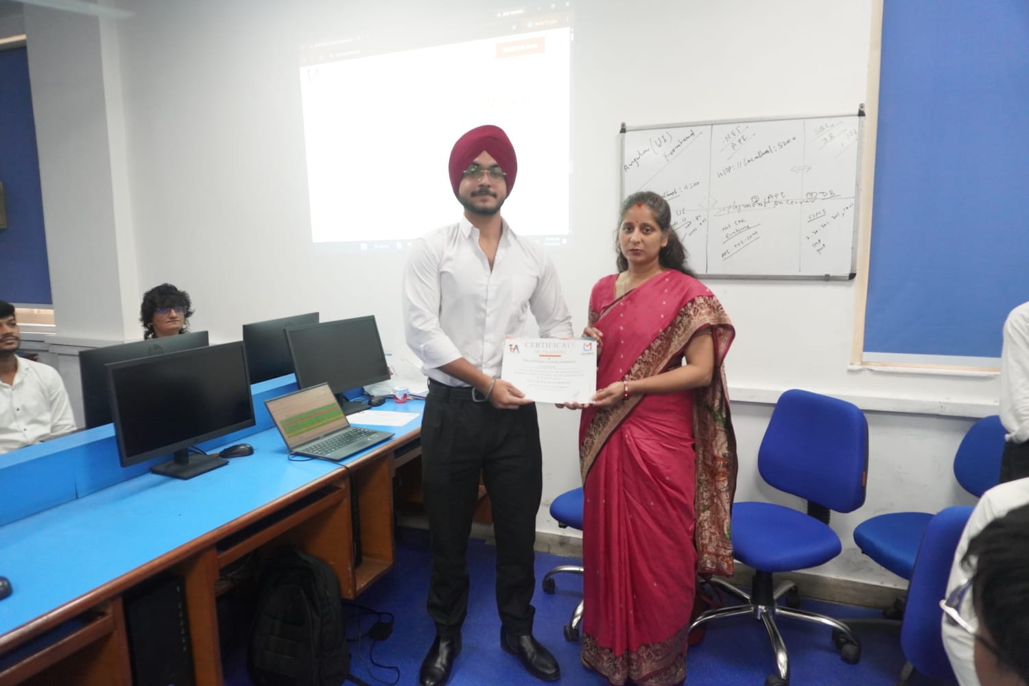 Student receiving Full Stack Development certificate at TuxAcademy